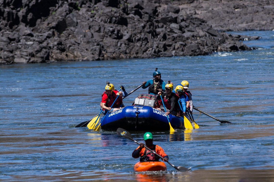 WBN Rafting-49 raft paddling on the Zambezi with safety kayaker