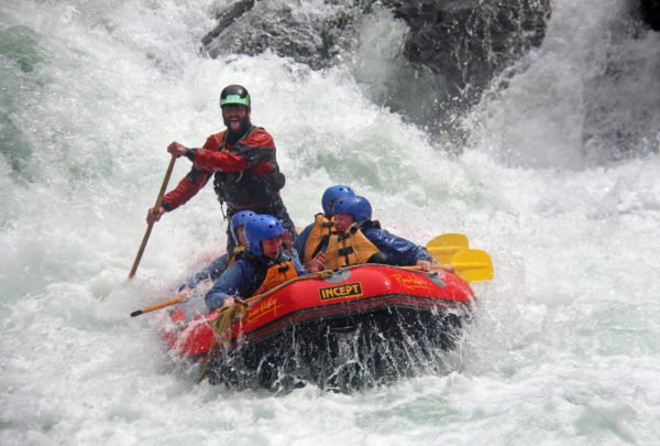 Orange raft with paddlers  in Grade 5 rapid on Rangitikei River