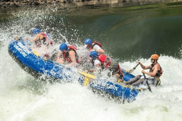Raft plunging into a rapid on the Zambezi River, Zambia