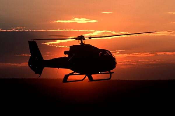 Helicopter flying back from Zambezi River at sunset