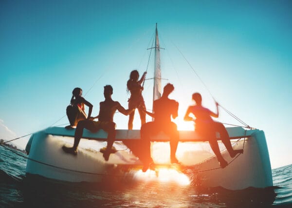 Young friends on catamaran yacht