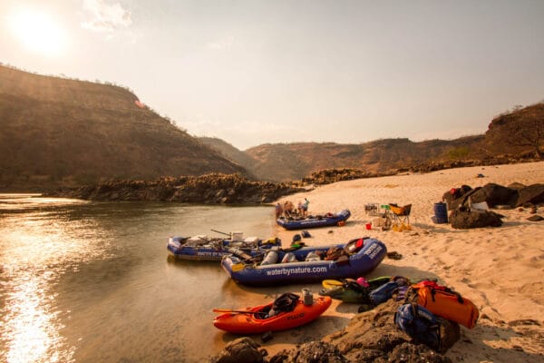 Campsite with rafts on beach on Zambezi River