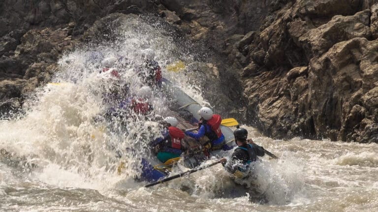 Raft crashing through whitewater in Nepal